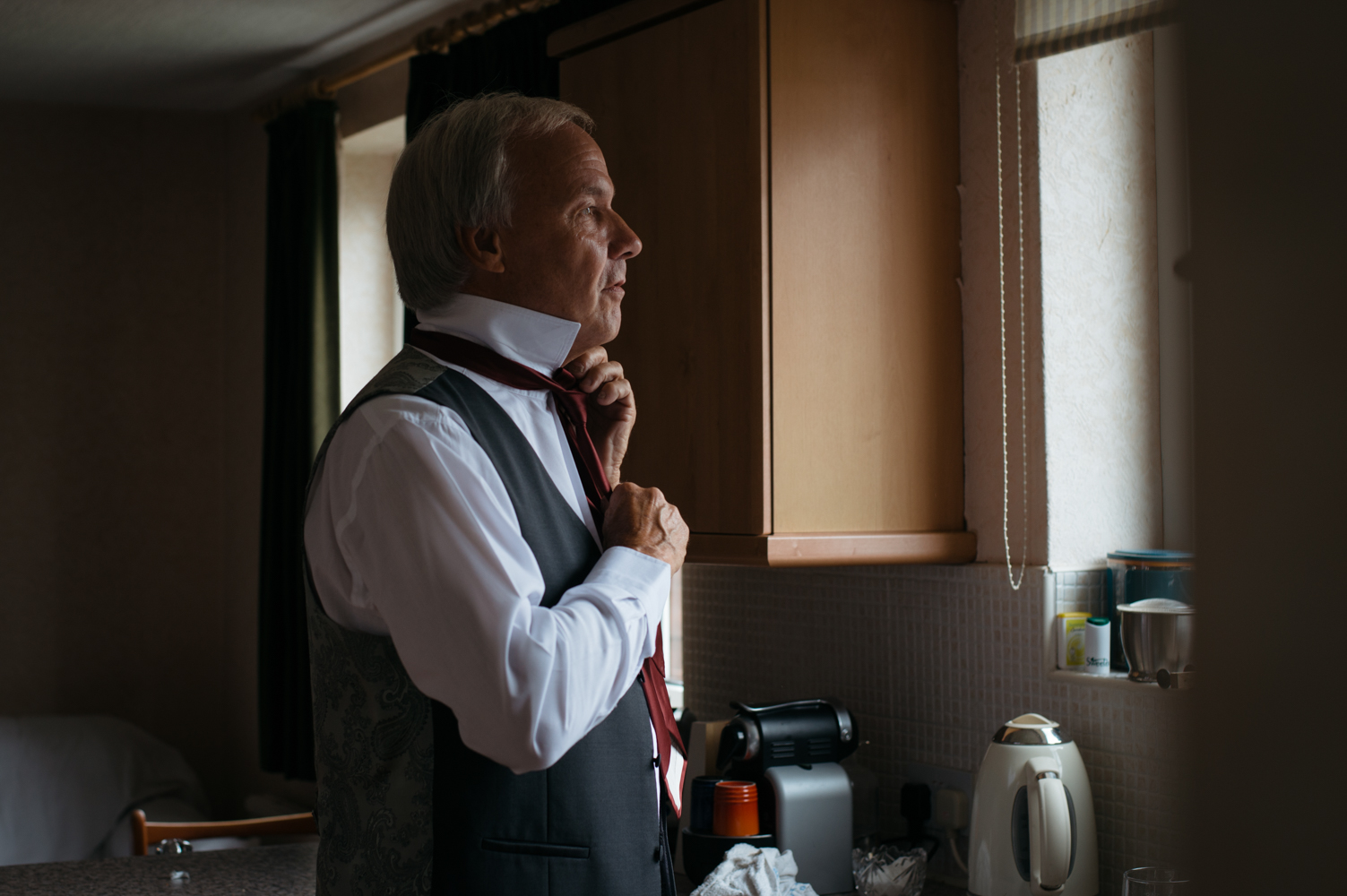 The brides father getting ready during morning preparations