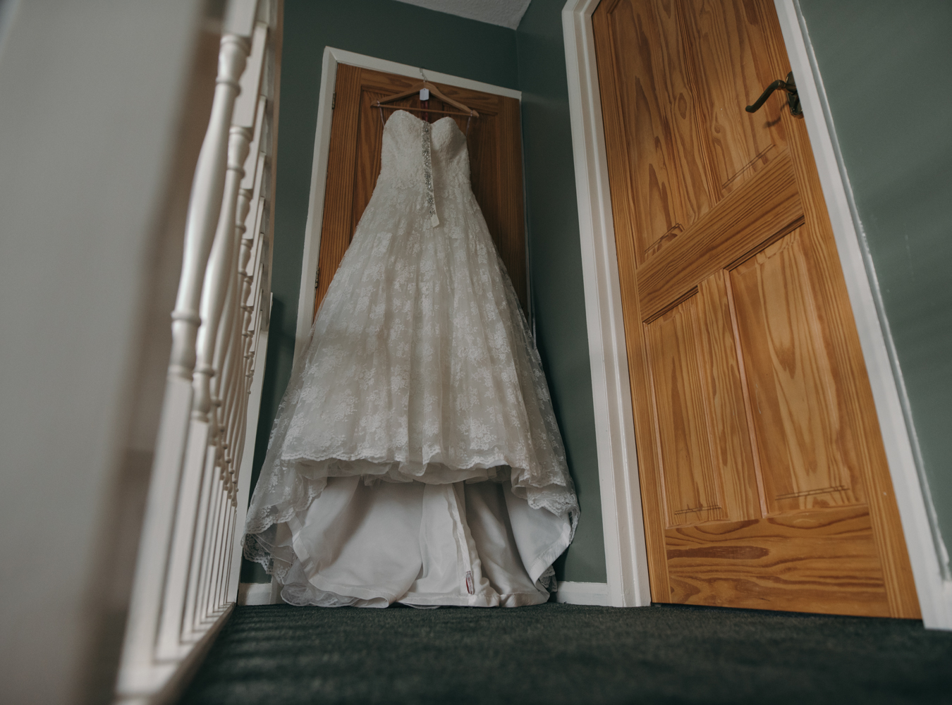 Brides dress hanging in the hallway