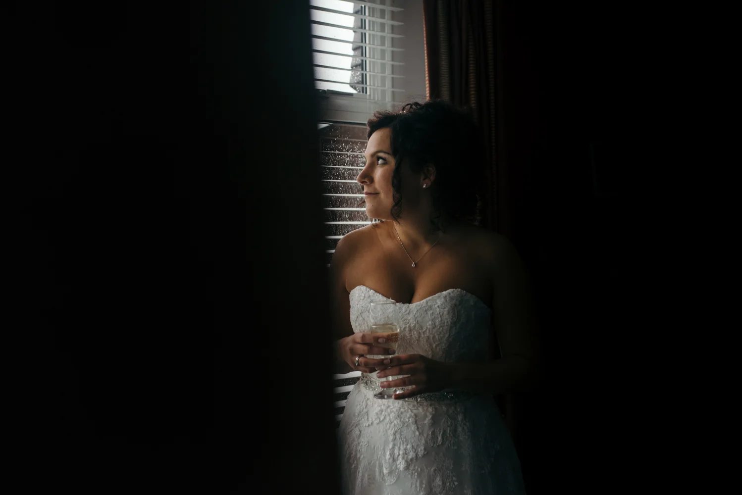 Bride portrait standing in the window