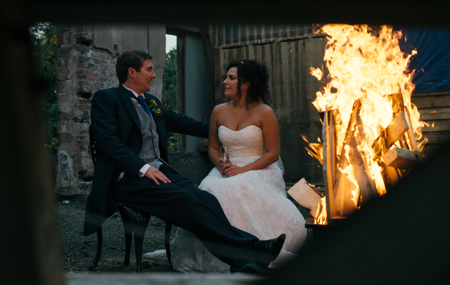 Bride and groom sitting by the fire