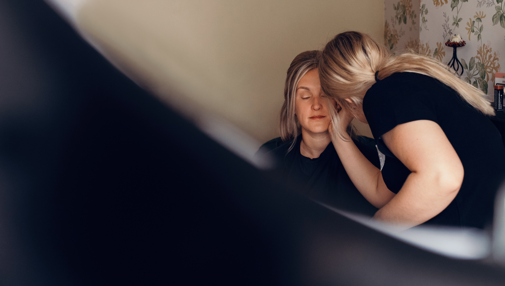 The bride having makeup applied during preparations