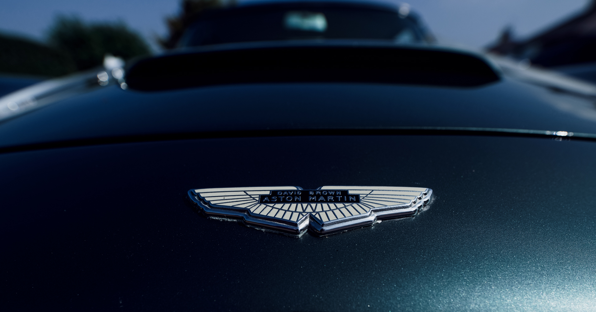 Front badge shot of the Aston Martin car being used to transport the bride and her father to church