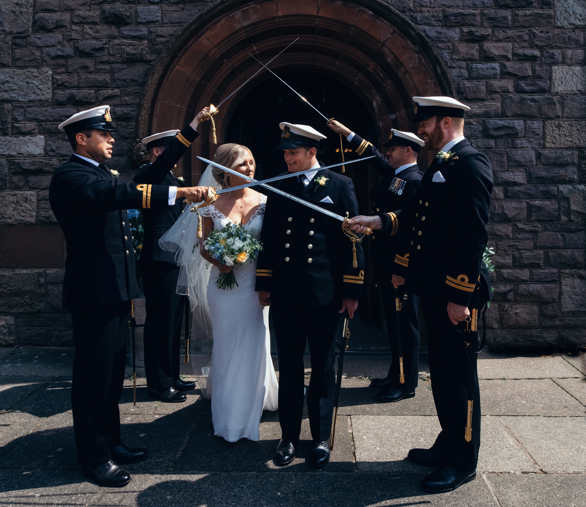 Bride and groom exit the church to a naval guard of honour