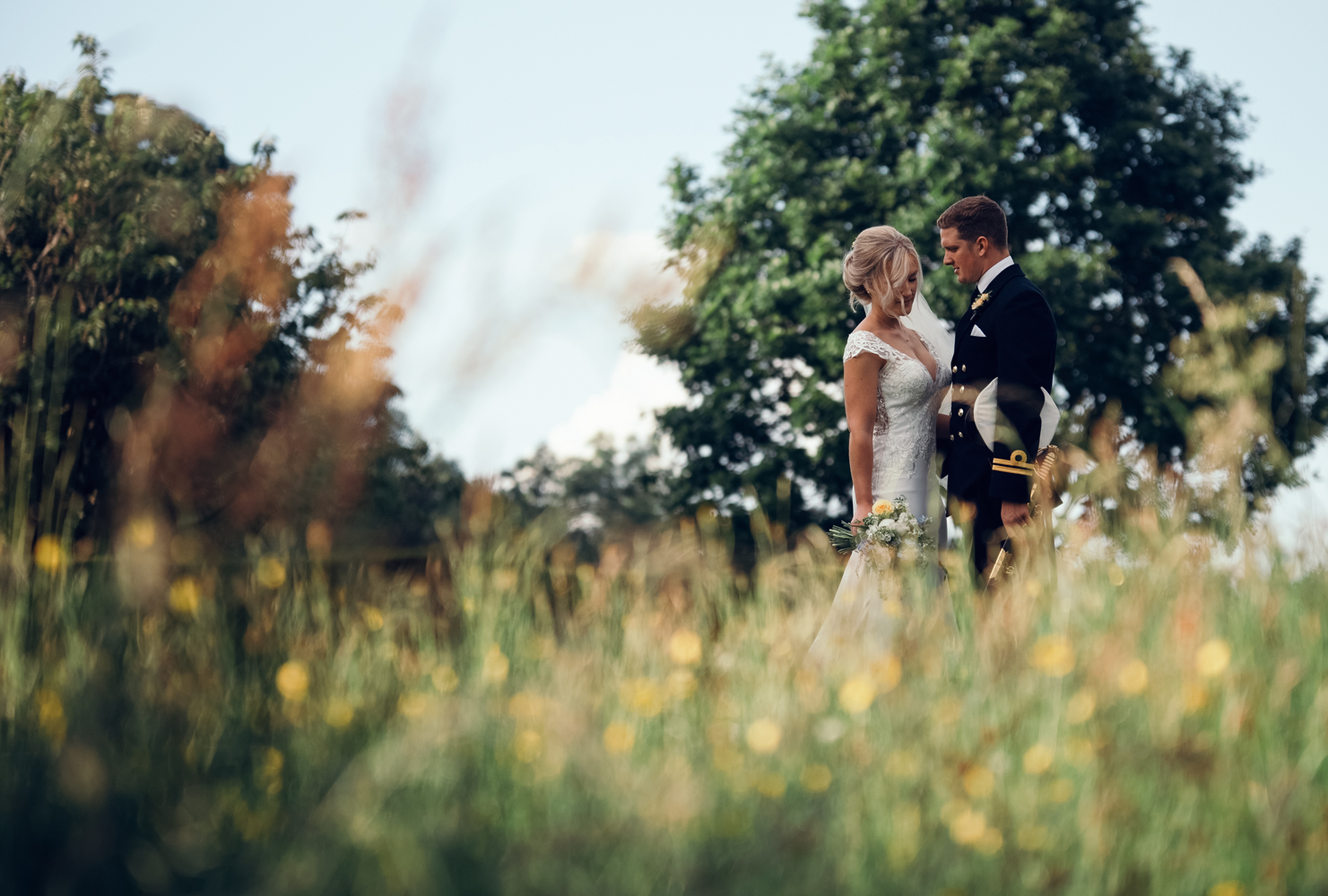 The bride and groom chatting in the gardens at Askham Hall