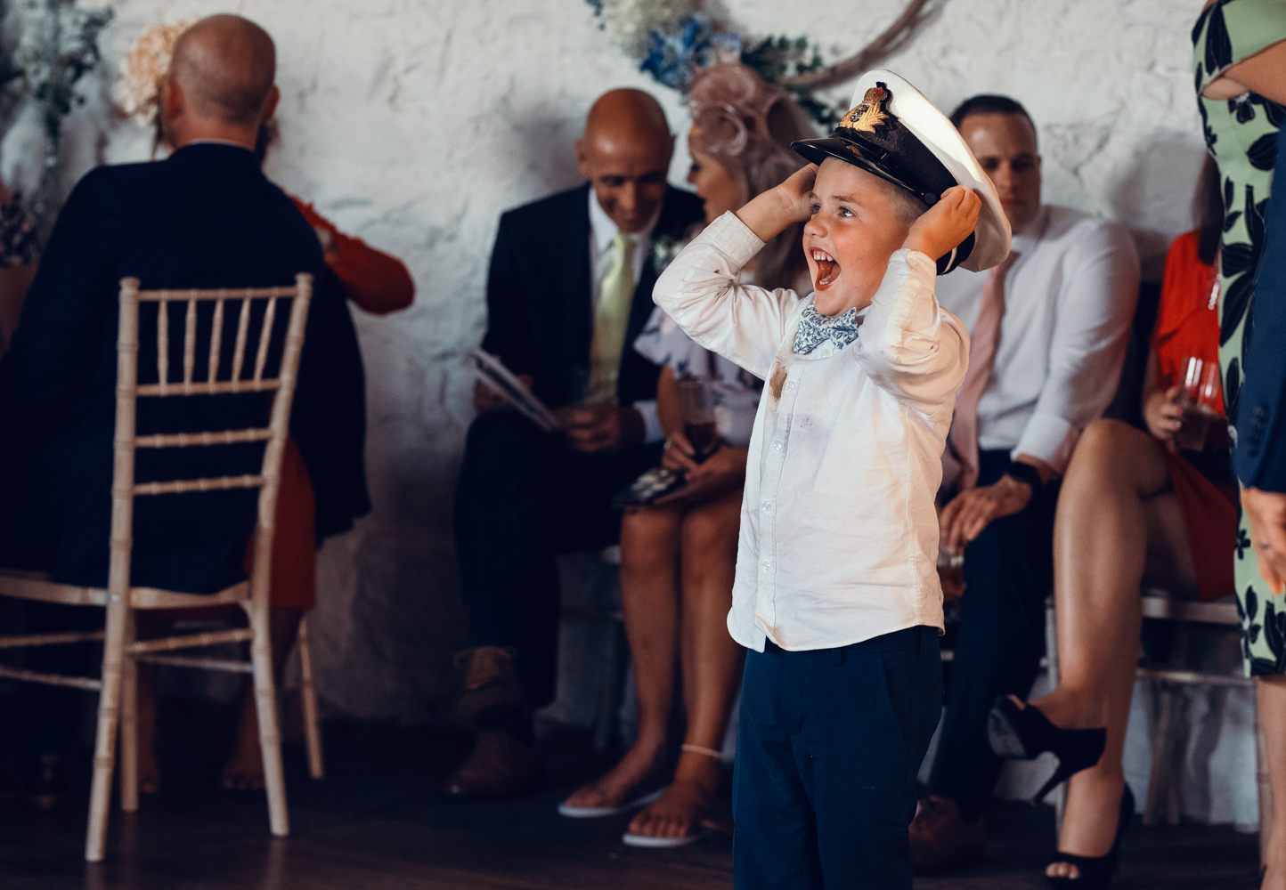 A young lad tries on a naval hat for size during the evening reception