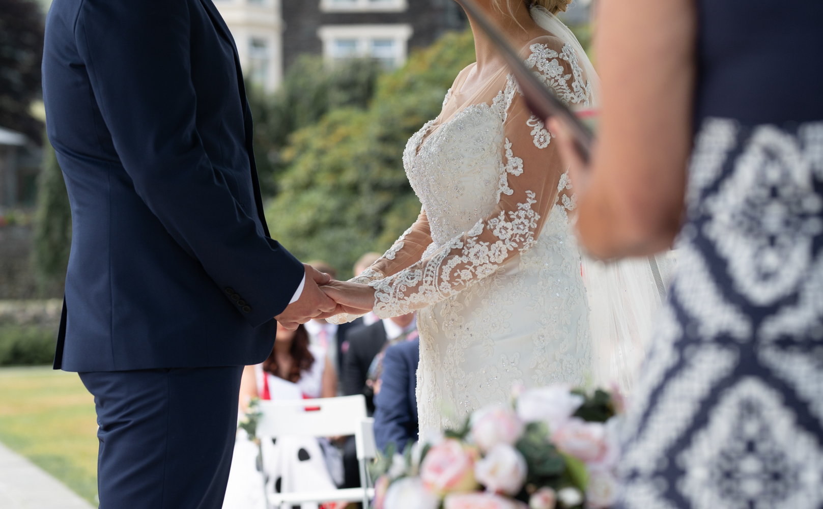 The bride and groom holding hands during the wedding ceremony