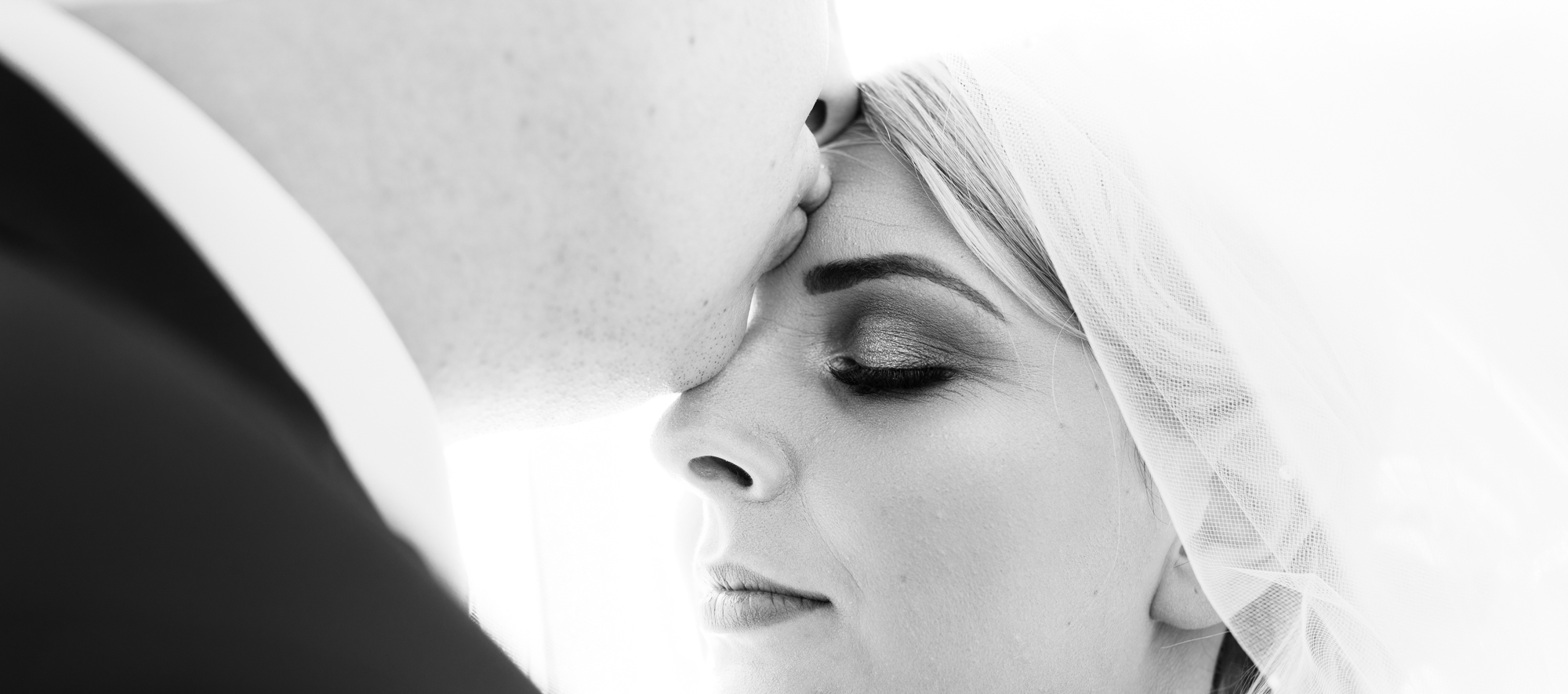 Close up image of the bride and groom in black and white