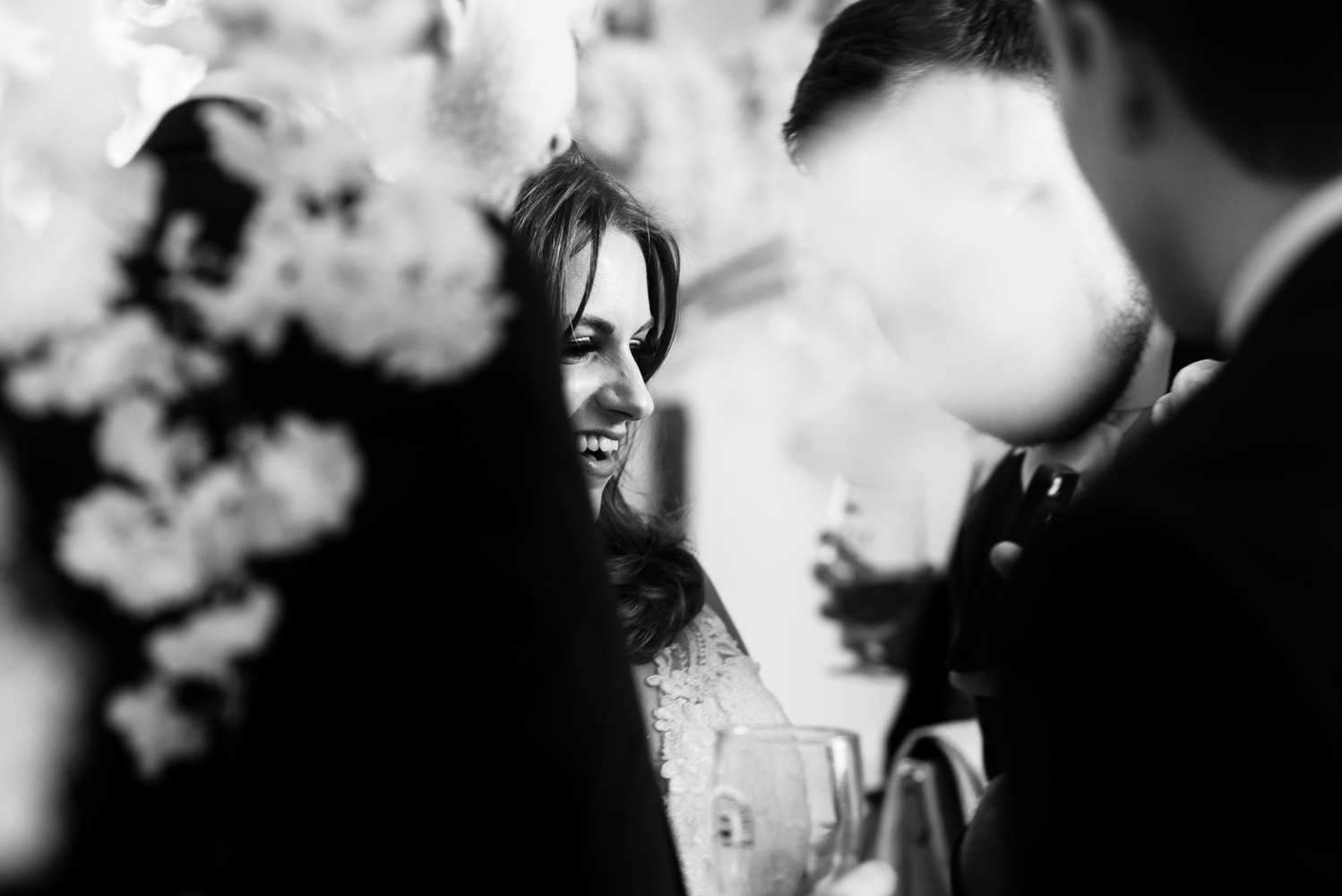 A black and white photo of the bride during the drinks reception