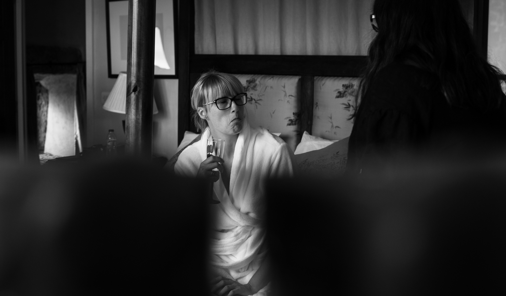 Black and white photo of a bridesmaid during bridal preparations