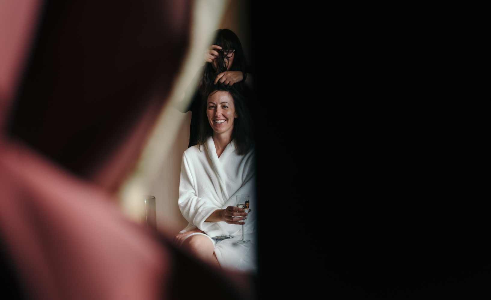 The bride Vicky having makeup and hair done during bridal preparations