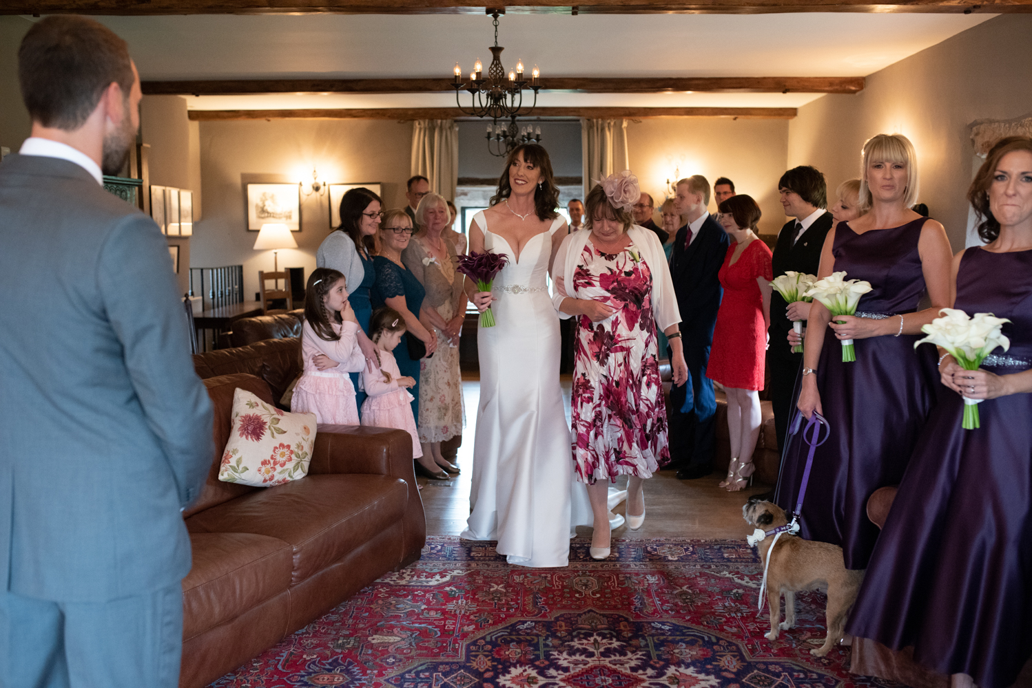 The bride being walked down the aisle by her mum