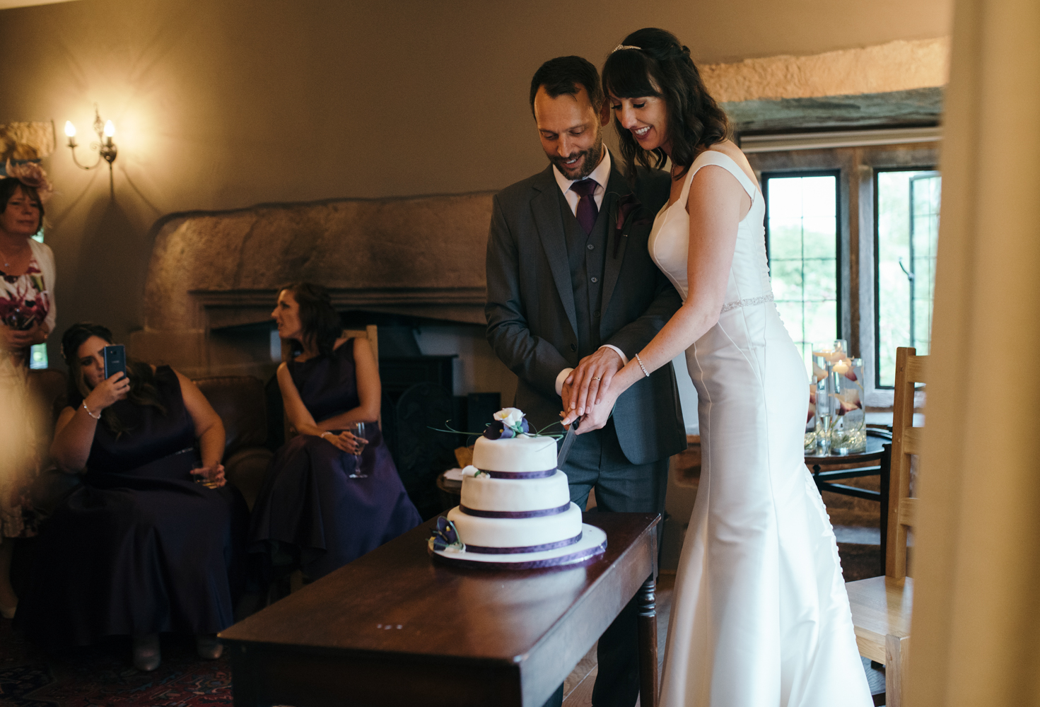 The bride and groom cutting the wedding cake