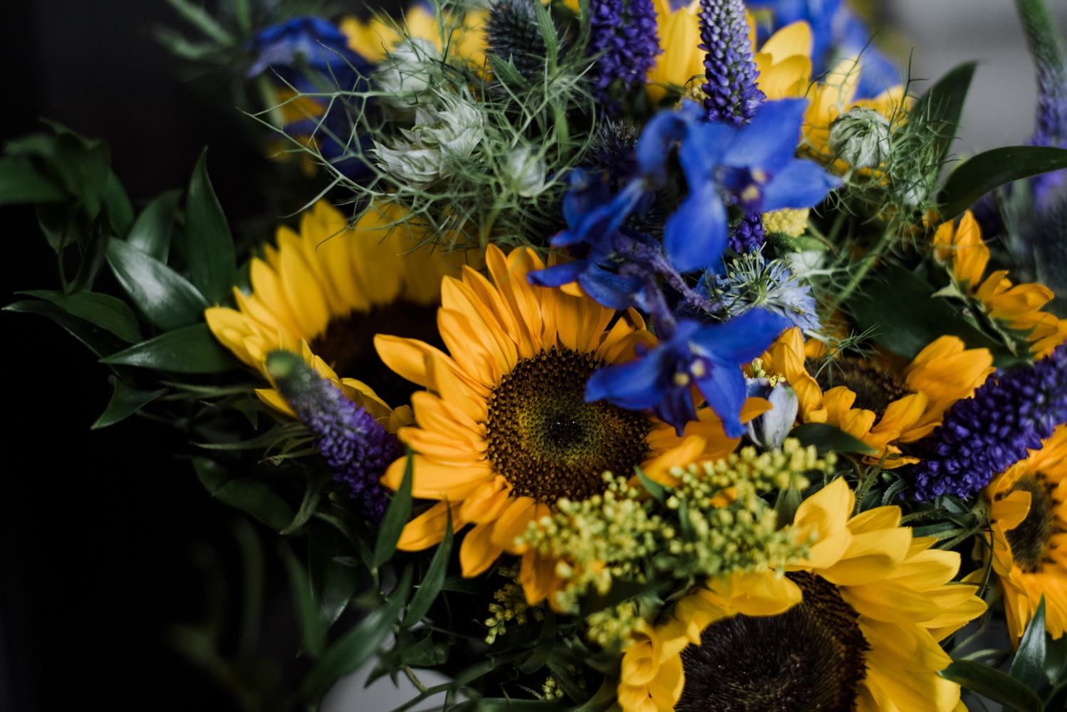 A close up photo of the brides bouquet featuring lots of sunflowers