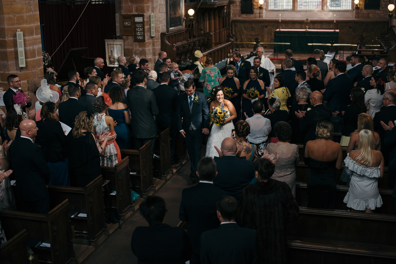 The bride and groom walking down the aisle together