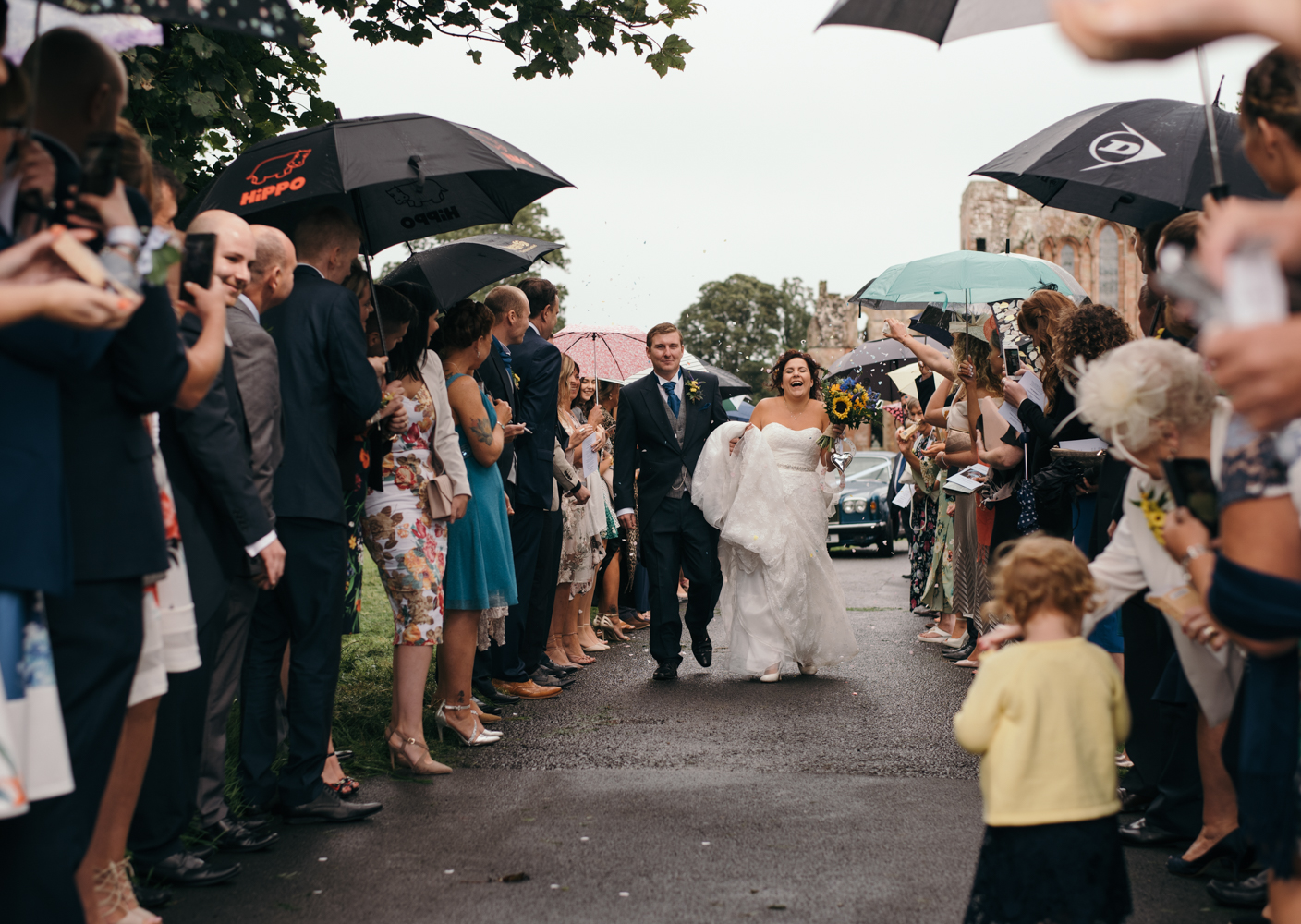 The bride and groom being showered with confetti