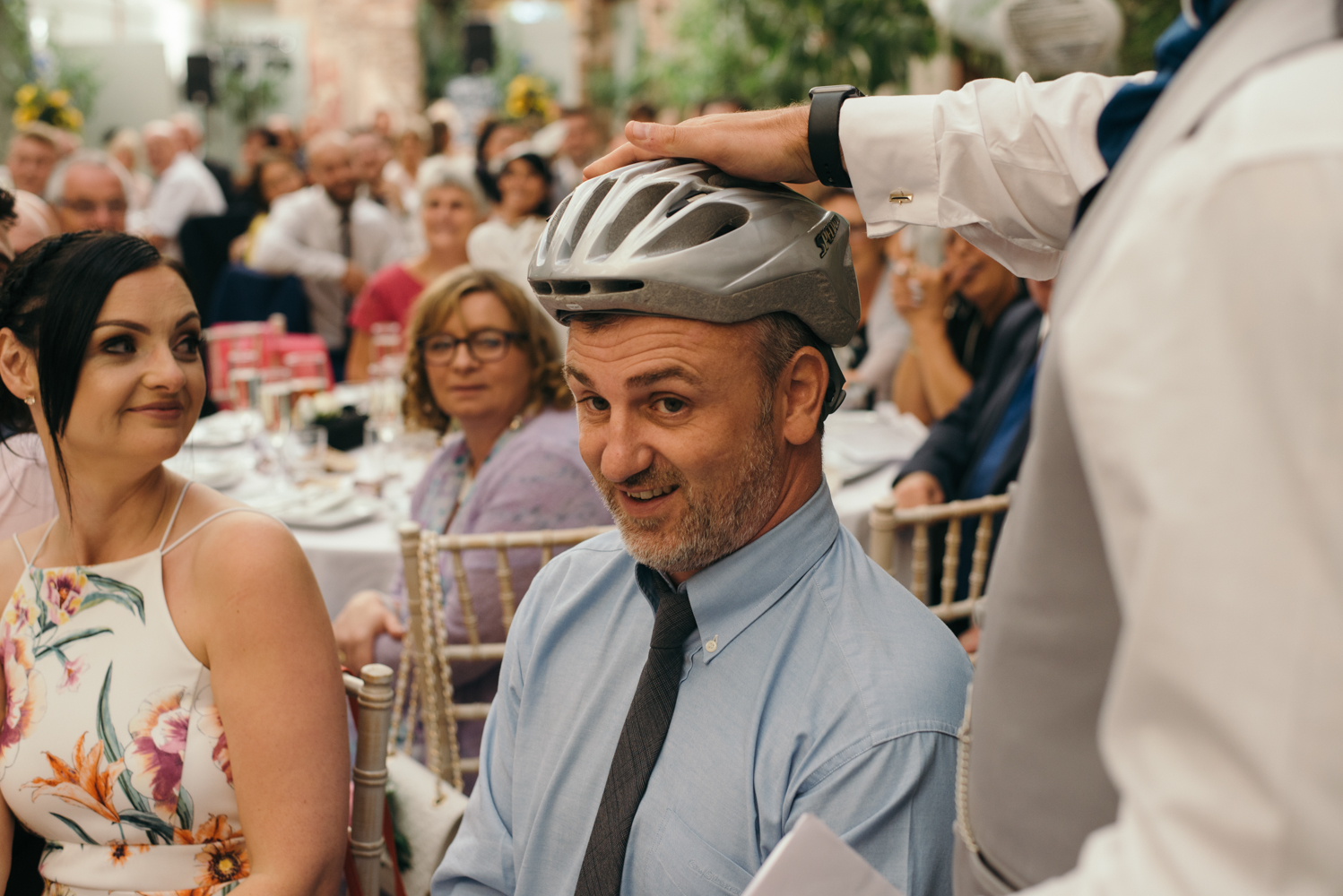 One of the male guests is presented with a cycle helmet during the speeches private joke