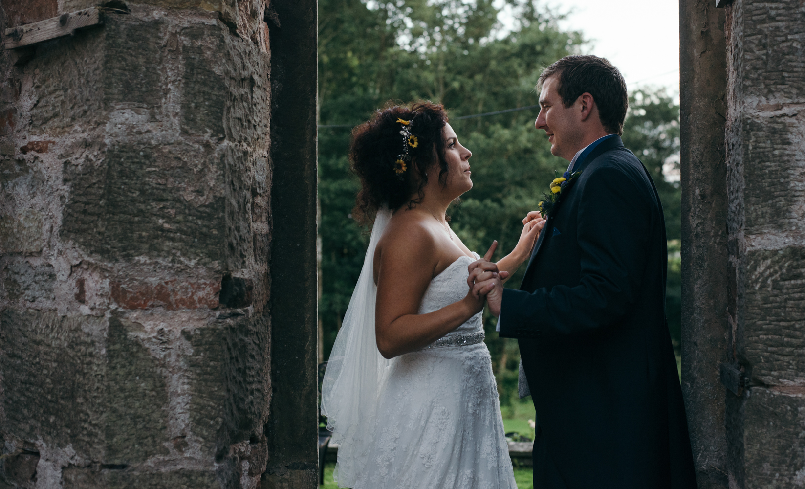 The bride and groom standing in an open doorway