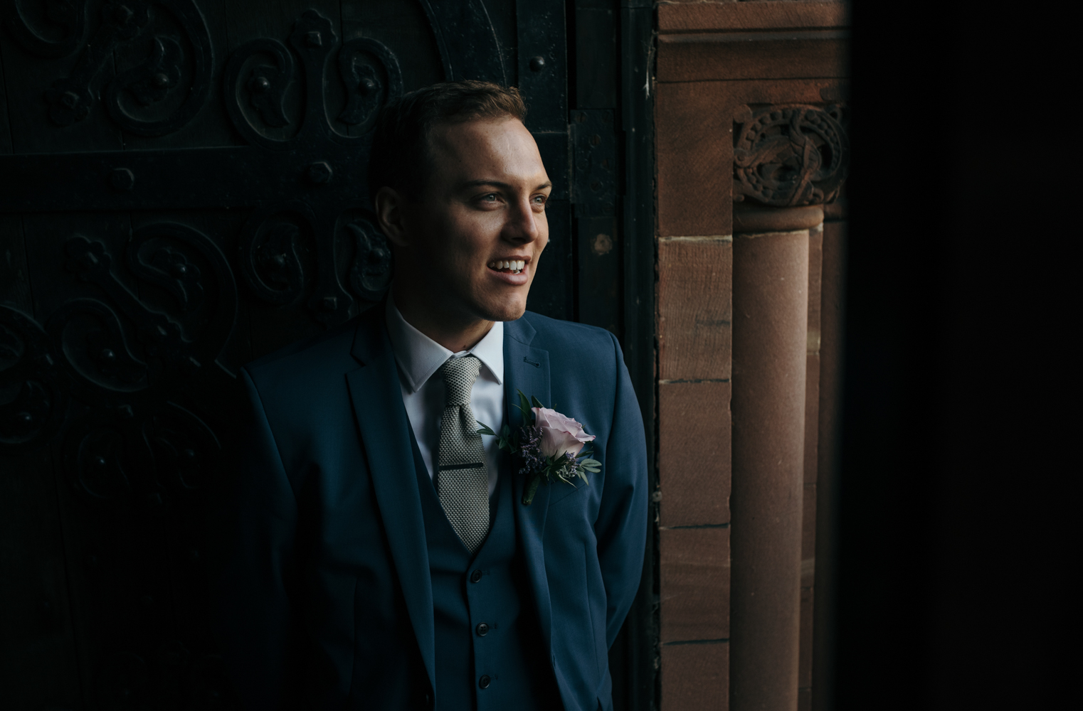 A rather nervous looking groom awaiting the arrival of the bride at church