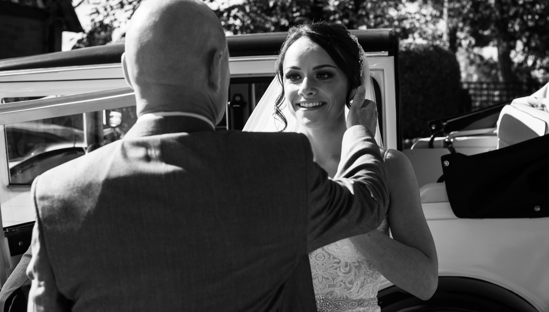 The brides father gives the bride a hug before going into the church