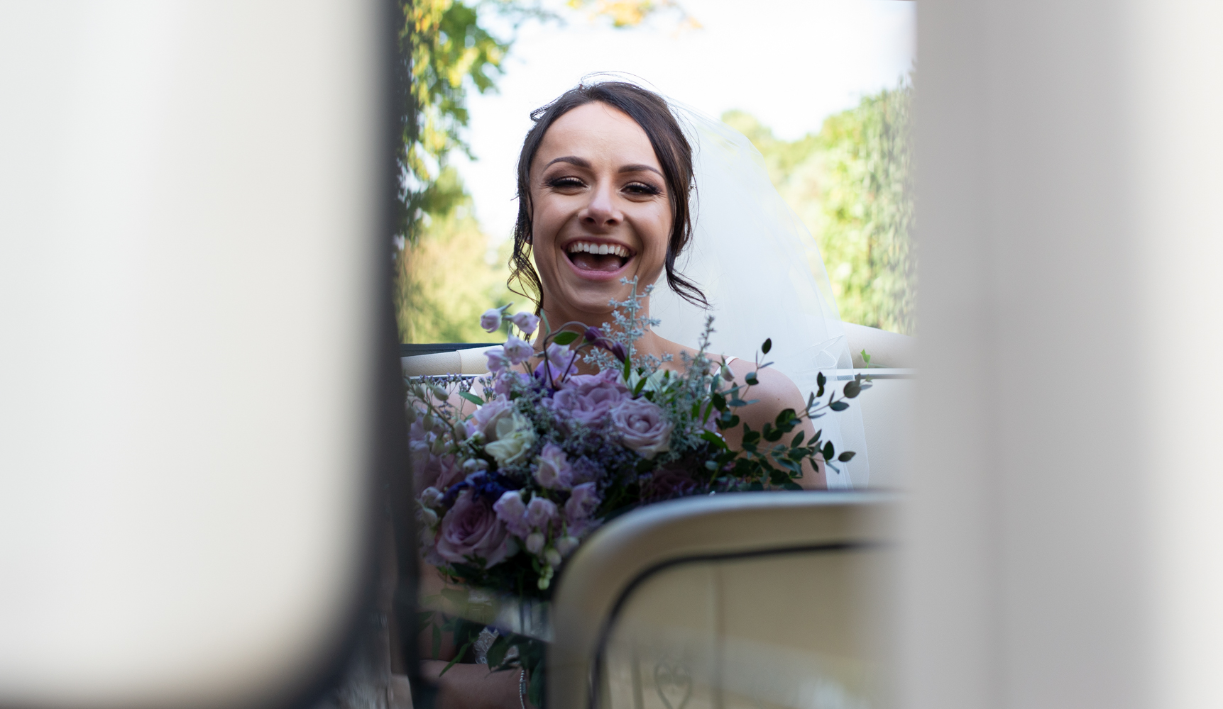 One very happy looking bride on arrival at Inglewood Manor for the wedding reception