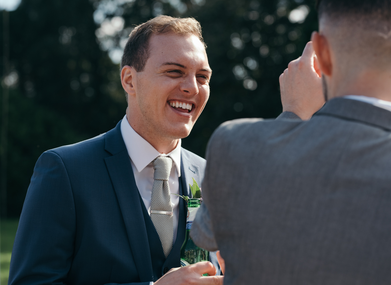 The groom chatting to some friends during the drinks reception