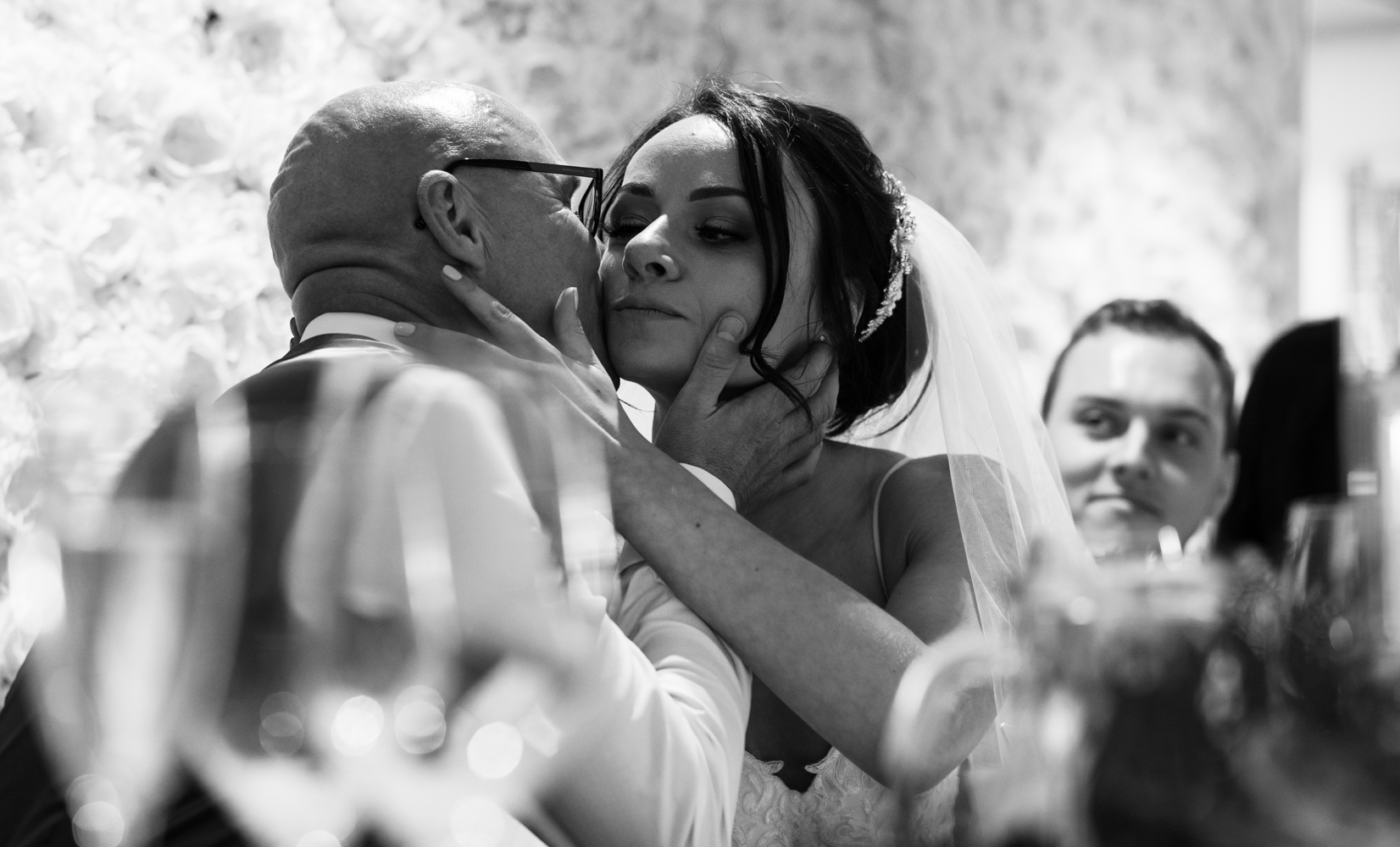 The bride giving her father a kiss during the speeches