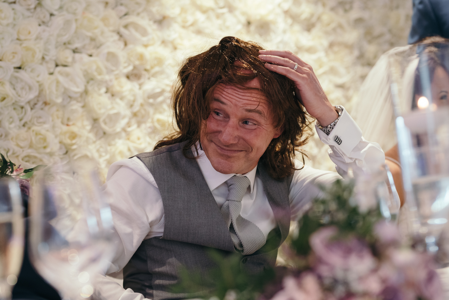 The brides father is presented with a wig during the grooms speech