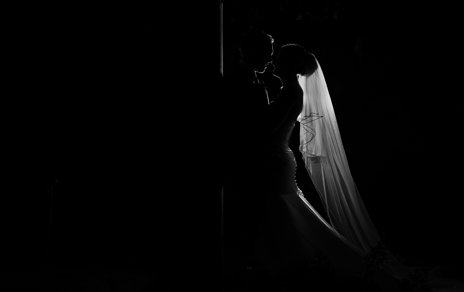 A Black and white photograph of the bride and groom taken using off camera lighting