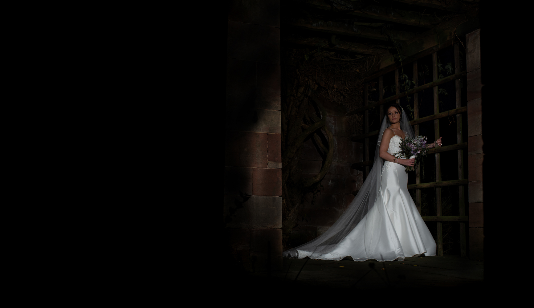 A single portrait of the bride in the alcoves at Inglewood Manor at night time