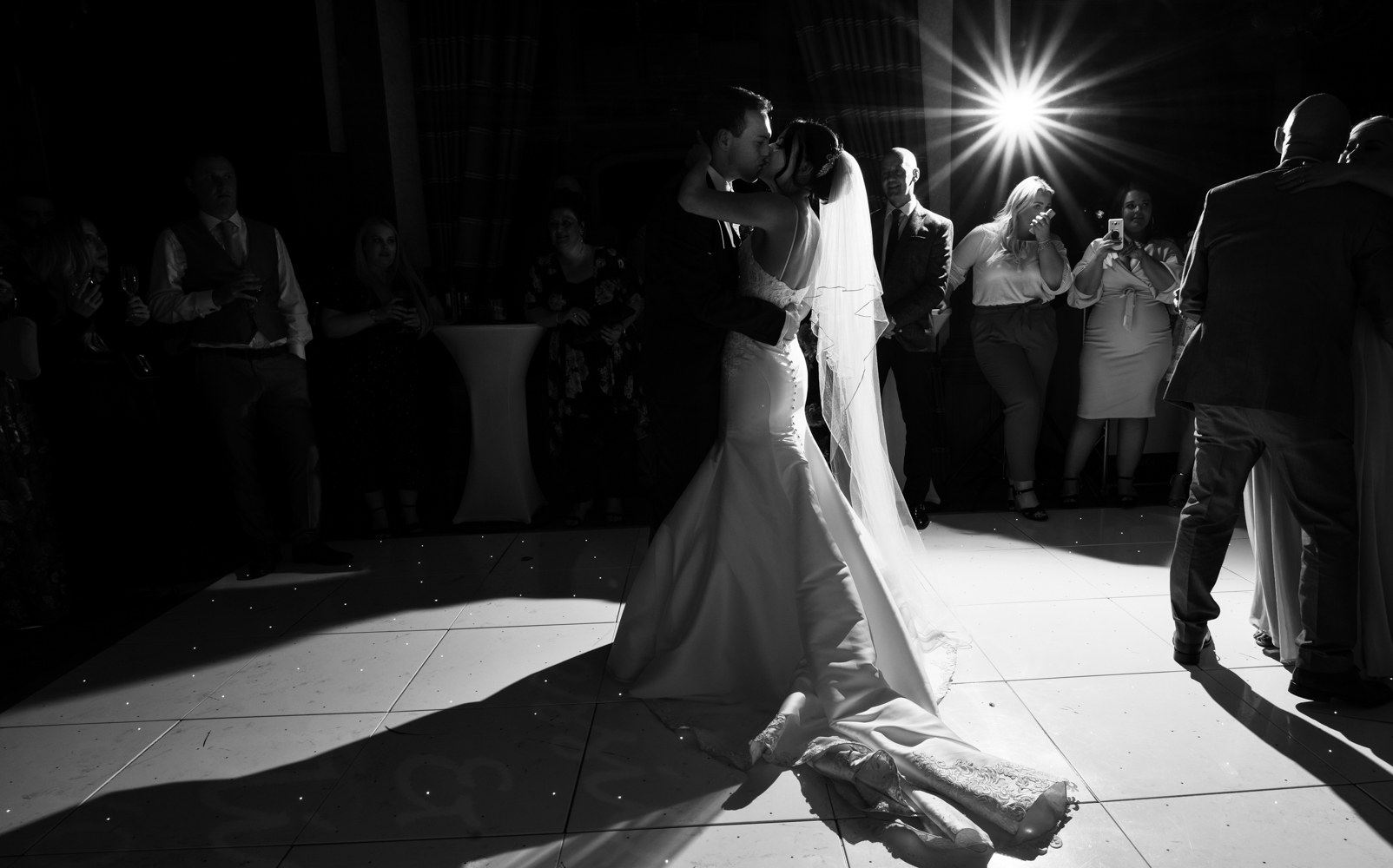 A black and white image of the bride and groom taken during their first dance together