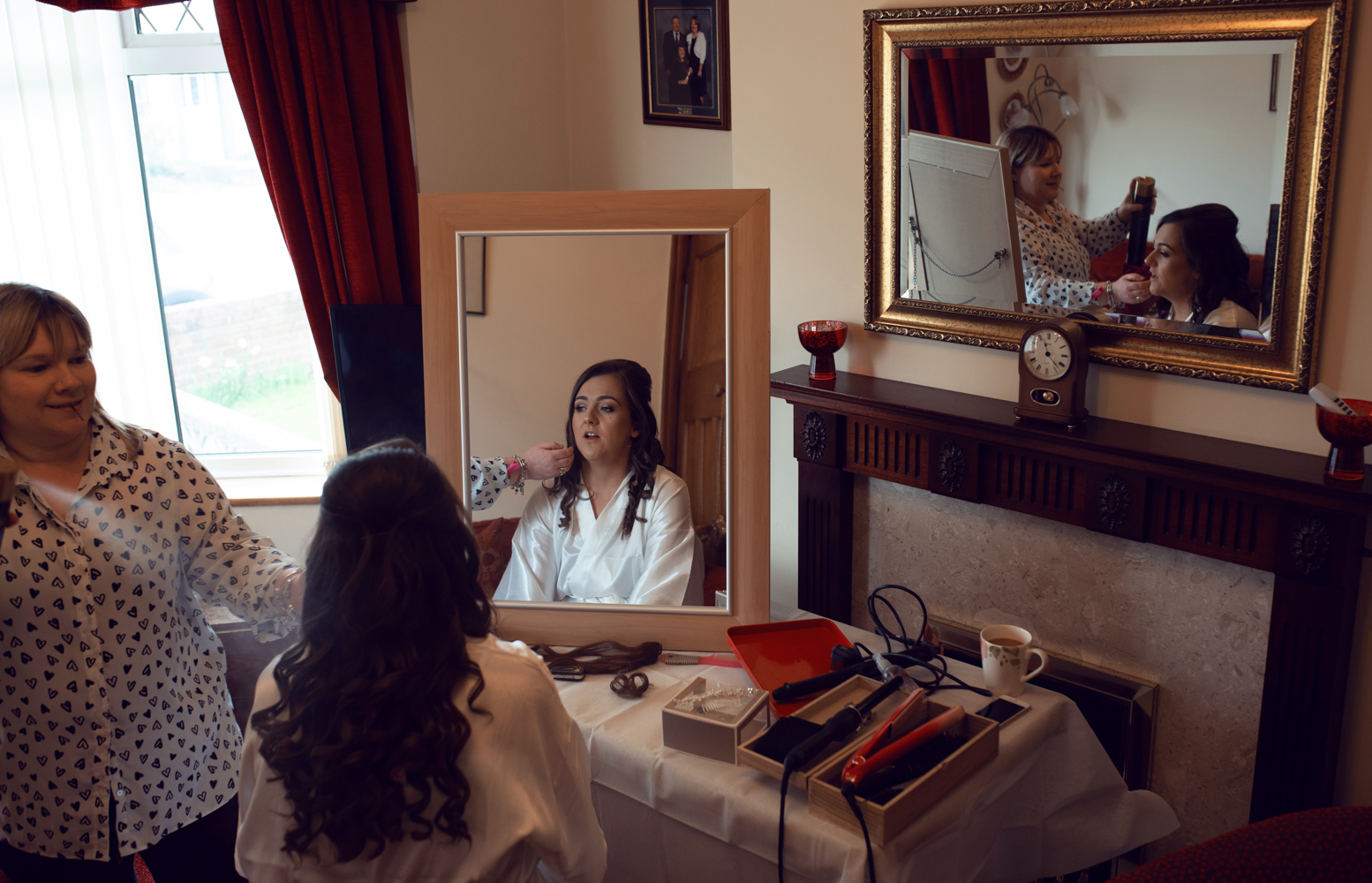 The bride during morning bridal preparations having her makeup applied