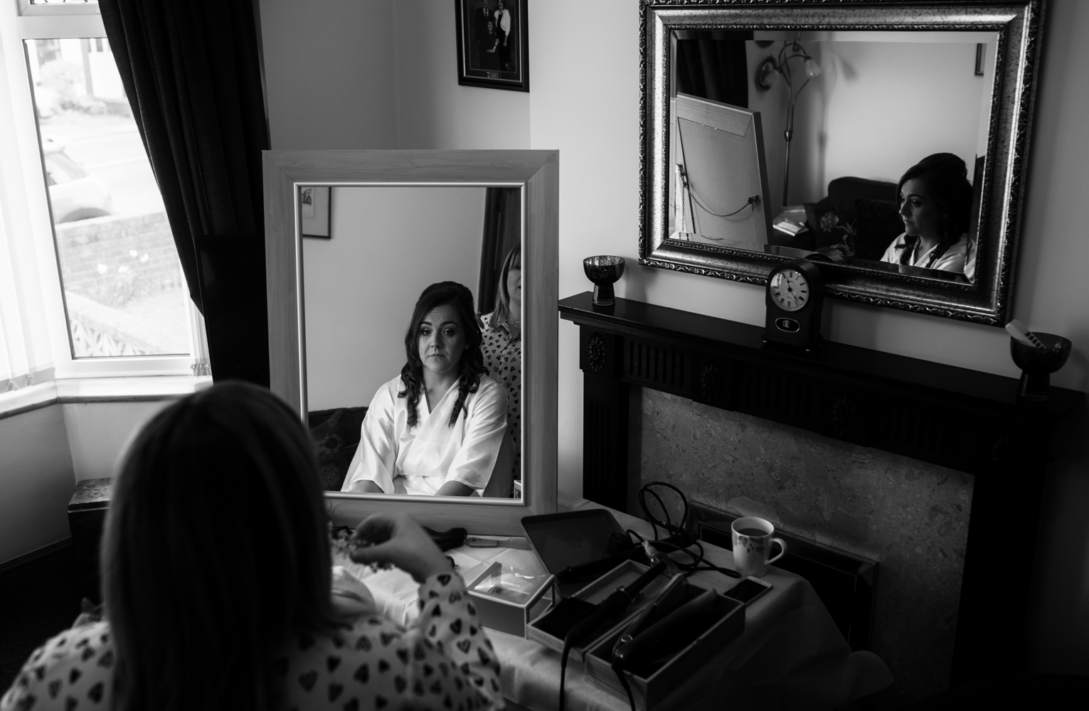 A Black and White image of the brides reflection in a mirror