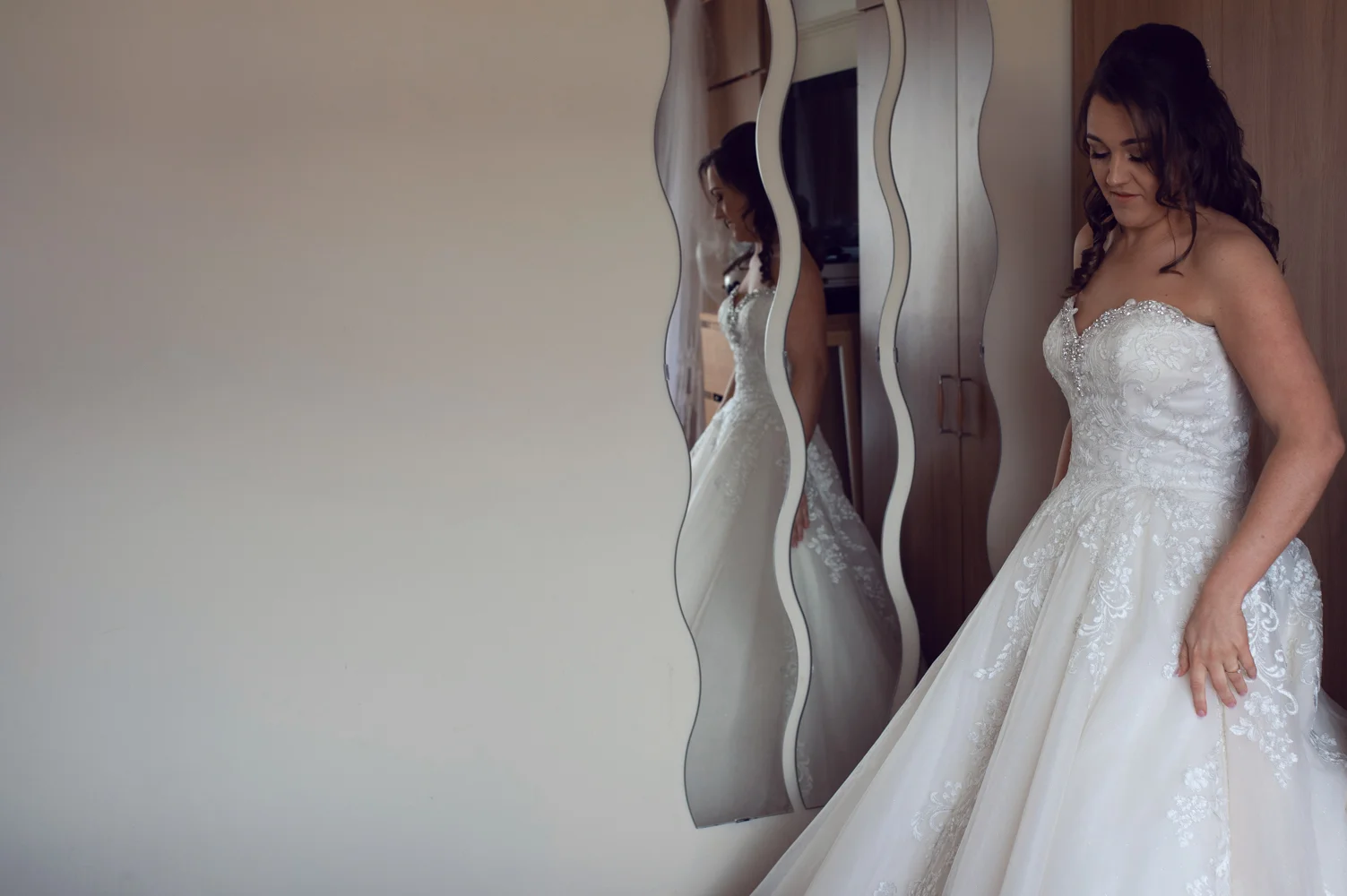 Photo of the bride in the quirky wall mirror