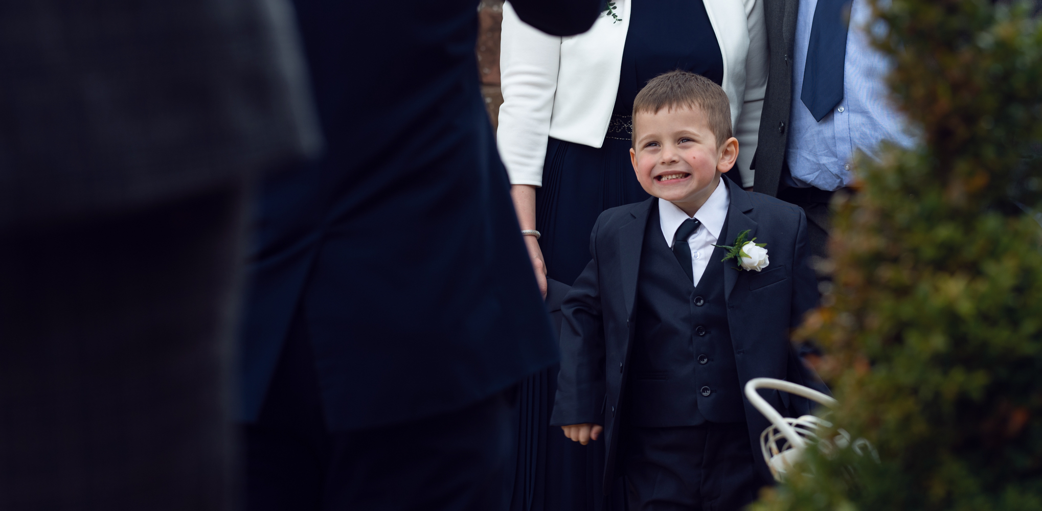 A young boy having a giggle outside the wedding venue