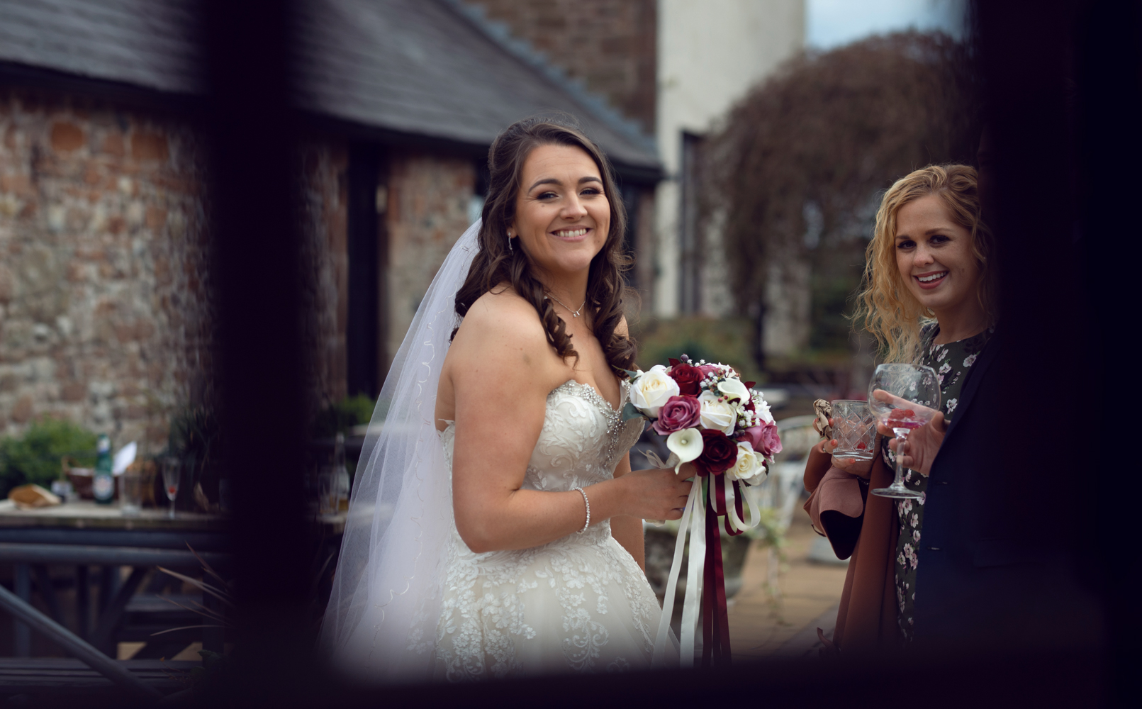 A candid photo of the bride chatting to one of her friends