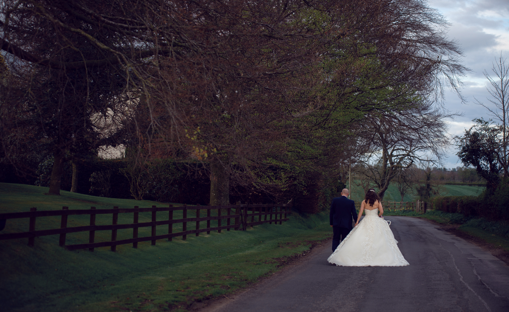 The bride and groom walking down the road during couples portrait session