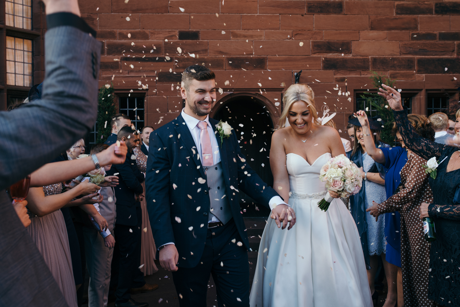 The bride and groom during the confetti shower