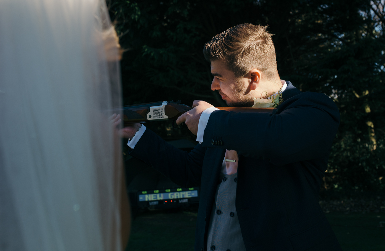 The groom trying his hand at laser clay pigeon shooting