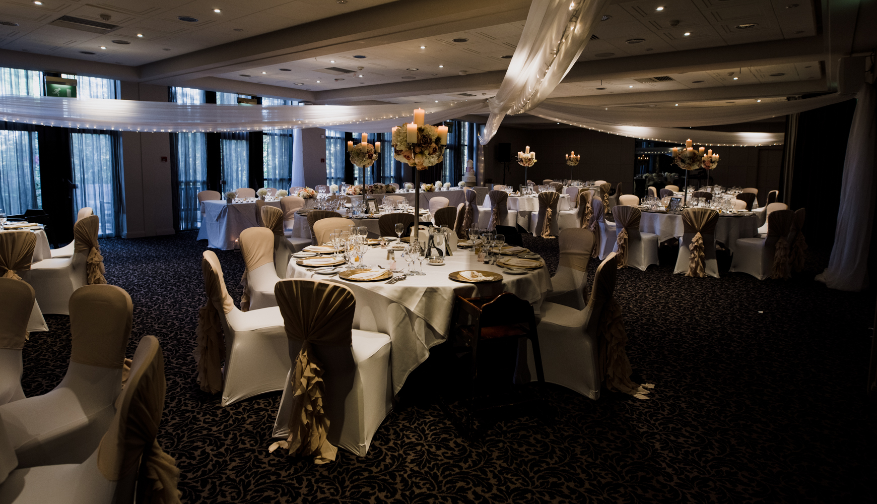 A wide angle image of the wedding reception room all set up for the wedding breakfast