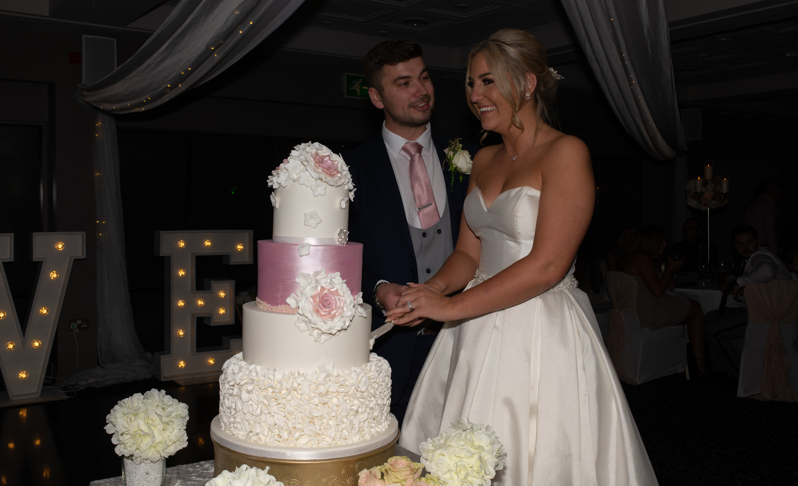 The bride and groom cutting the wedding cake