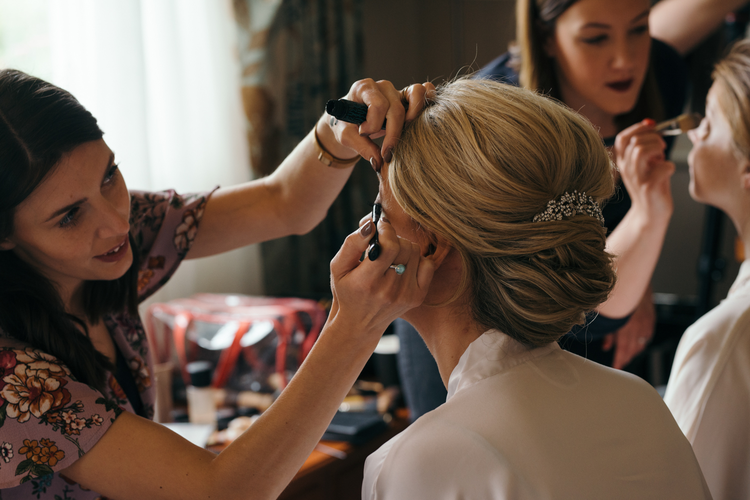 The bride having her eye makeup applied