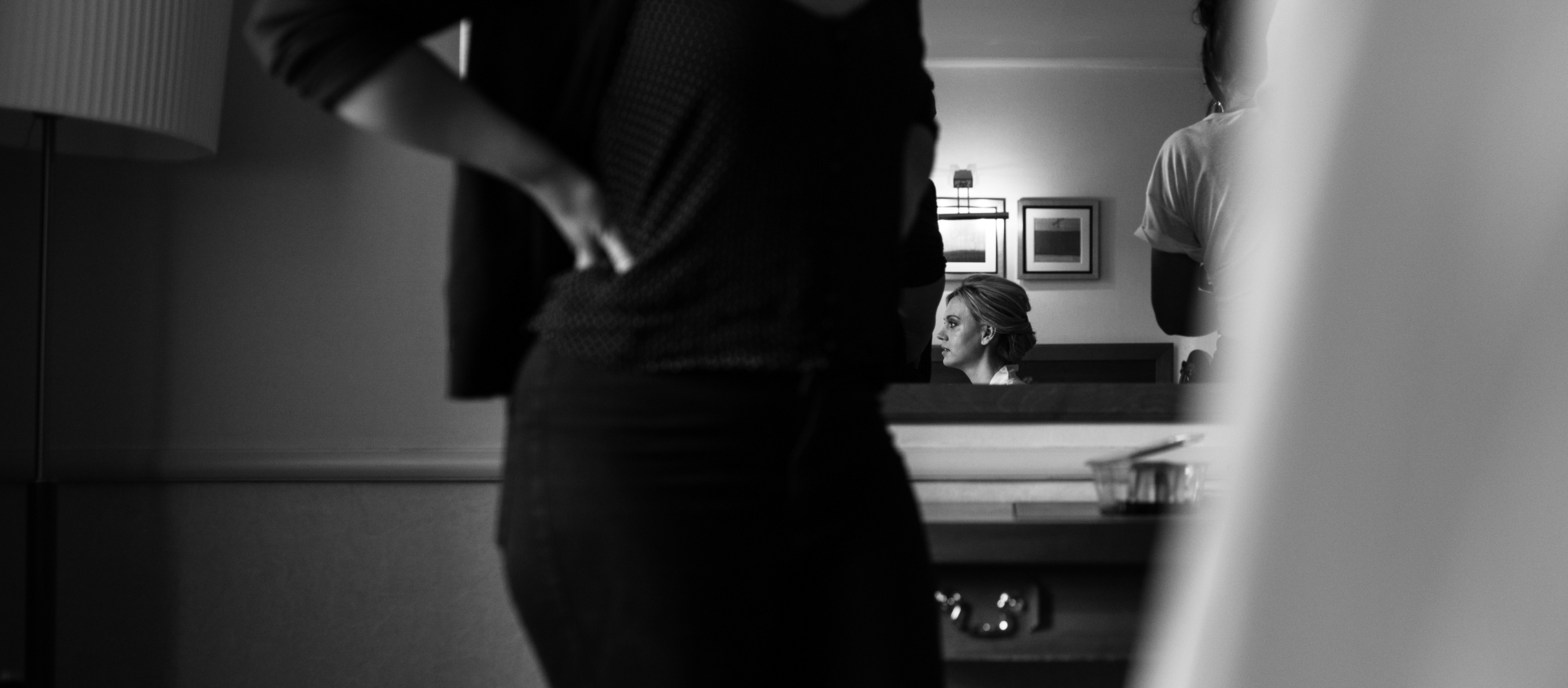 A black and white photo of the bride during preparations