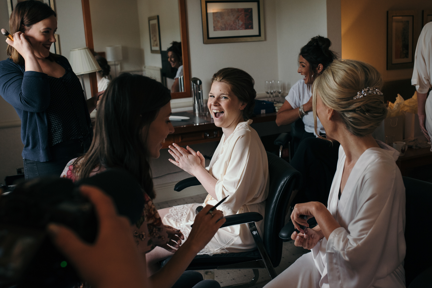 A bridesmaid having a good laugh during morning preparations