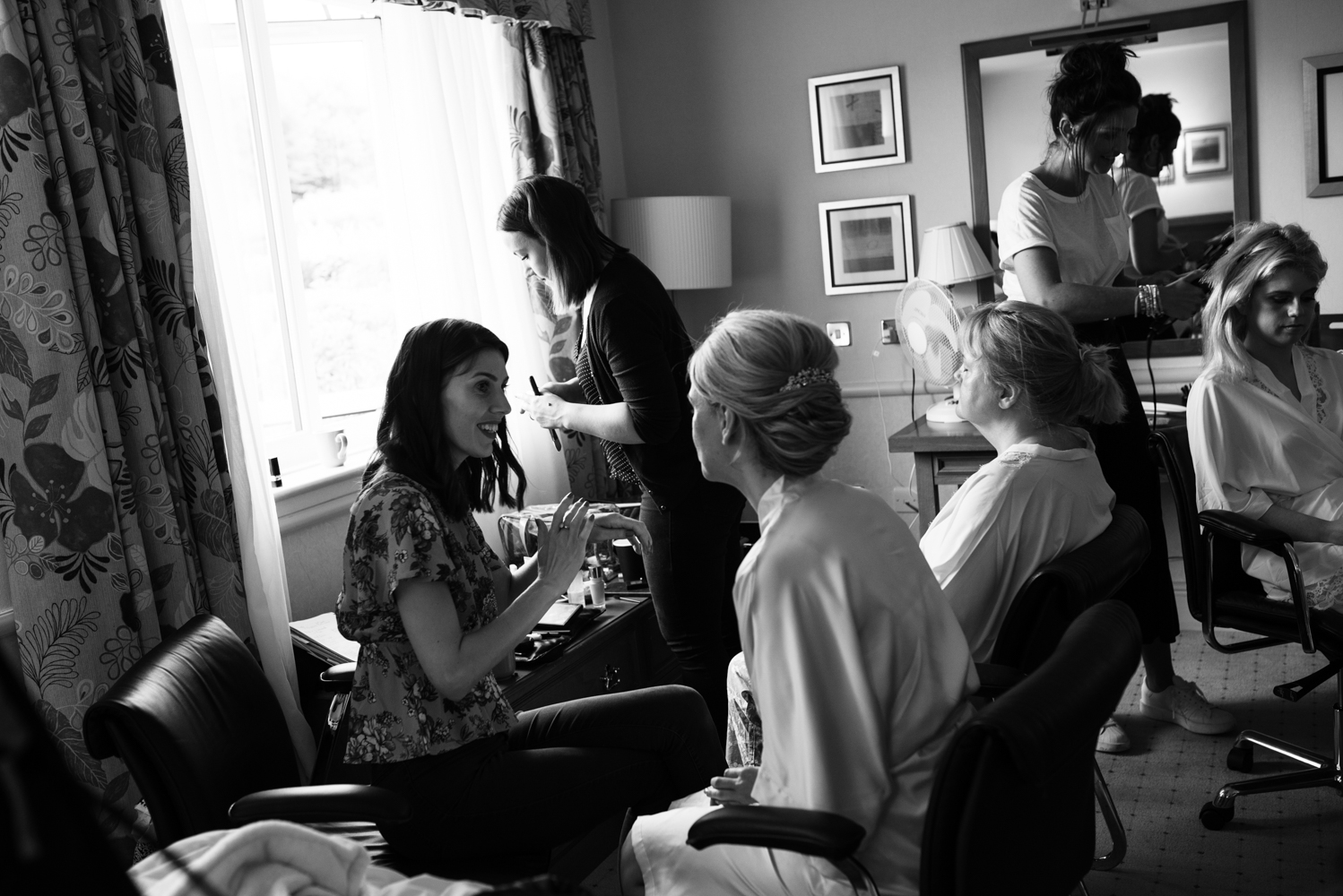 Another black and white photo of the the bride and bridesmaids during preparations