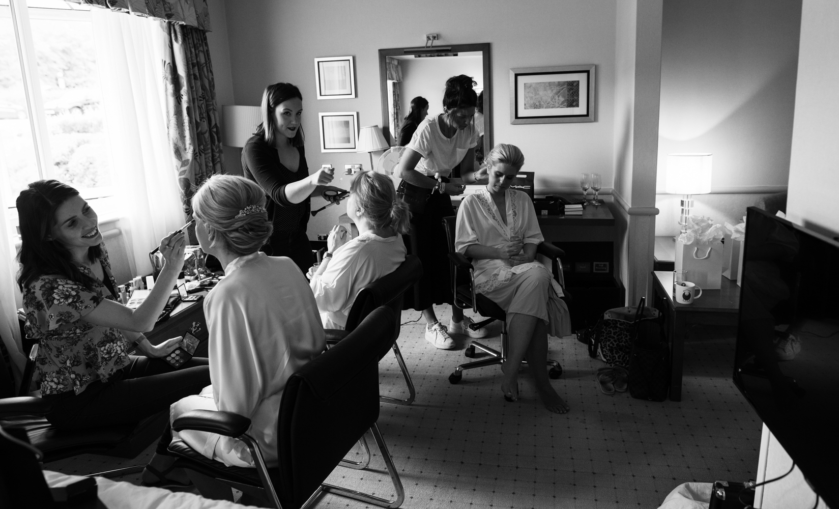 A black and white whole room photo during bridal preparations