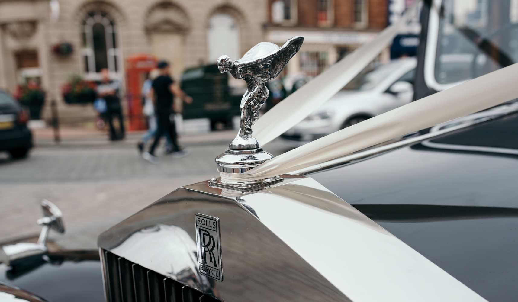 The silver lady on the front of the Rolls Royce as it arrives at the church