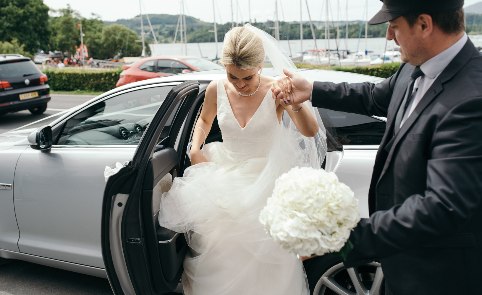 The bride getting out of the car at Low Wood Bay Hotel