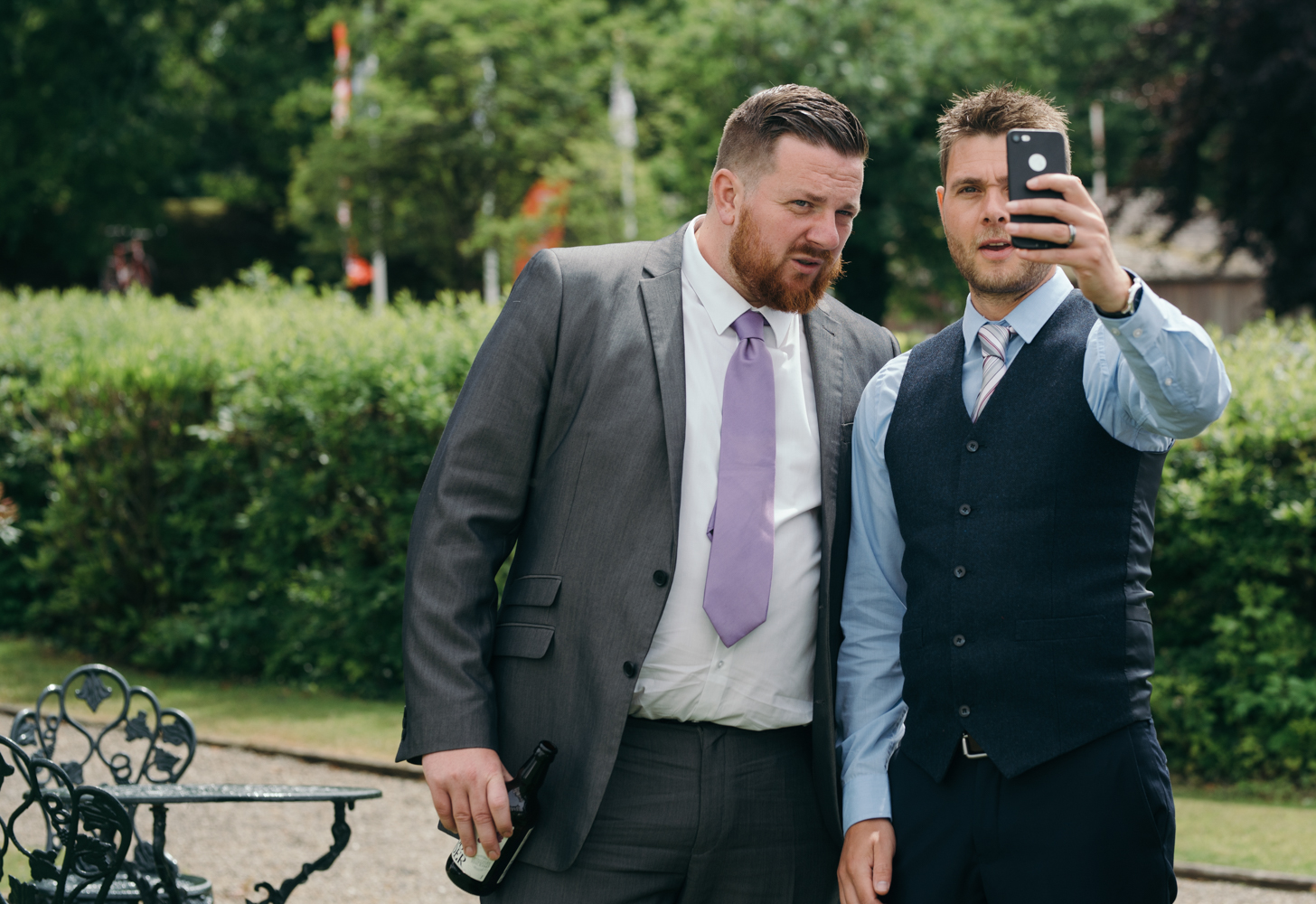 To male wedding guests caught taking a selfie together