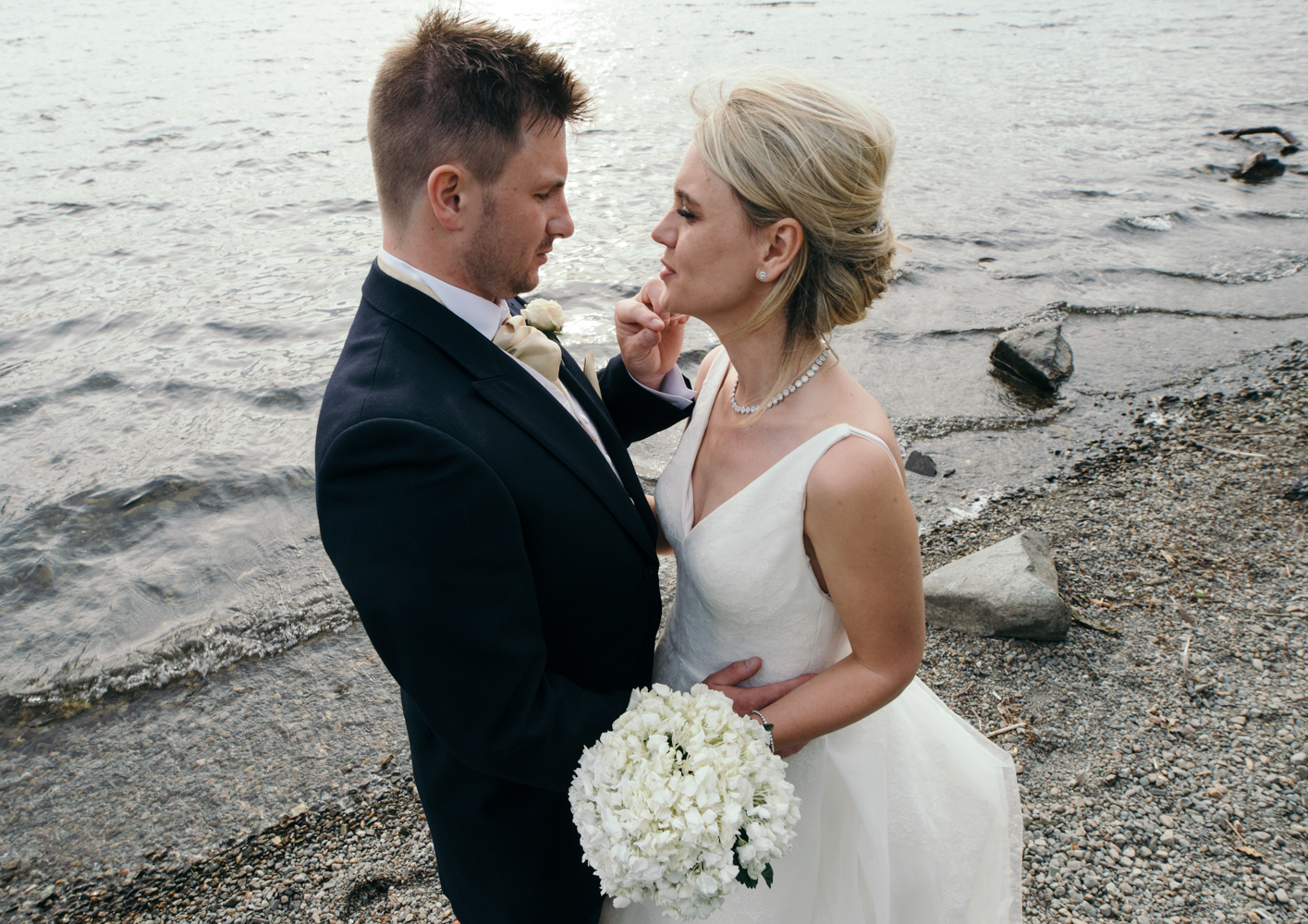 Overhead view of the bride and groom taken down by the lakeside