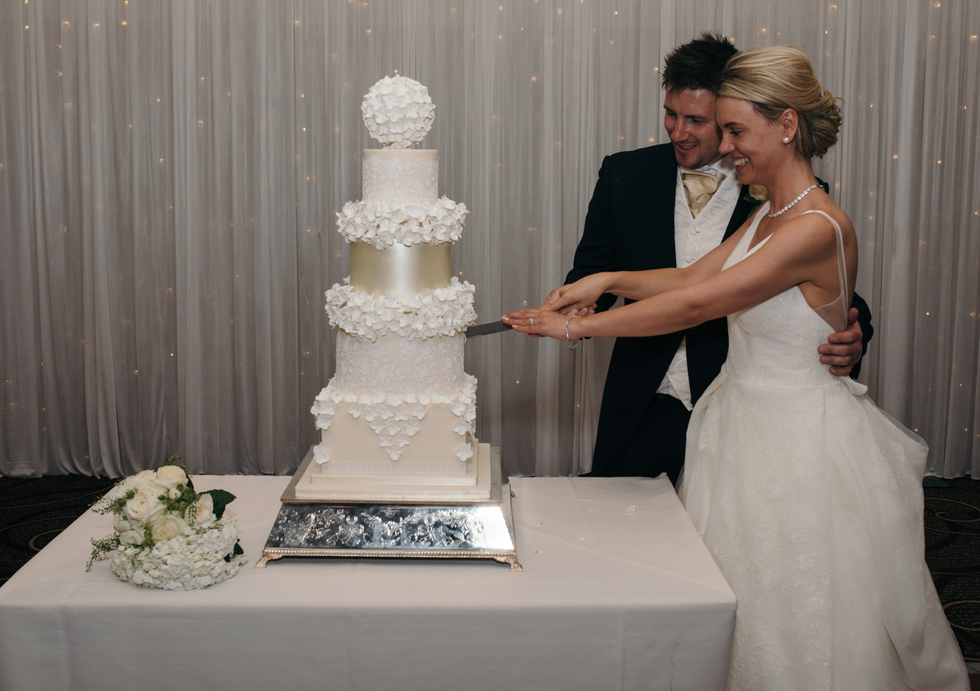 The bride and groom cutting the wedding cake